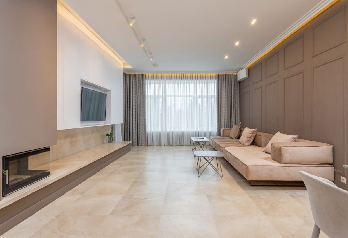 Sofa floated a few inches away from the wall with an angled chair in a small living room layout