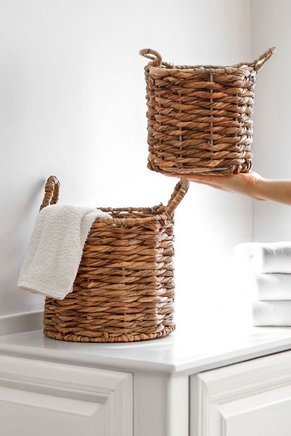 Hidden storage bench and woven baskets keeping clutter out of sight in a tidy small living room