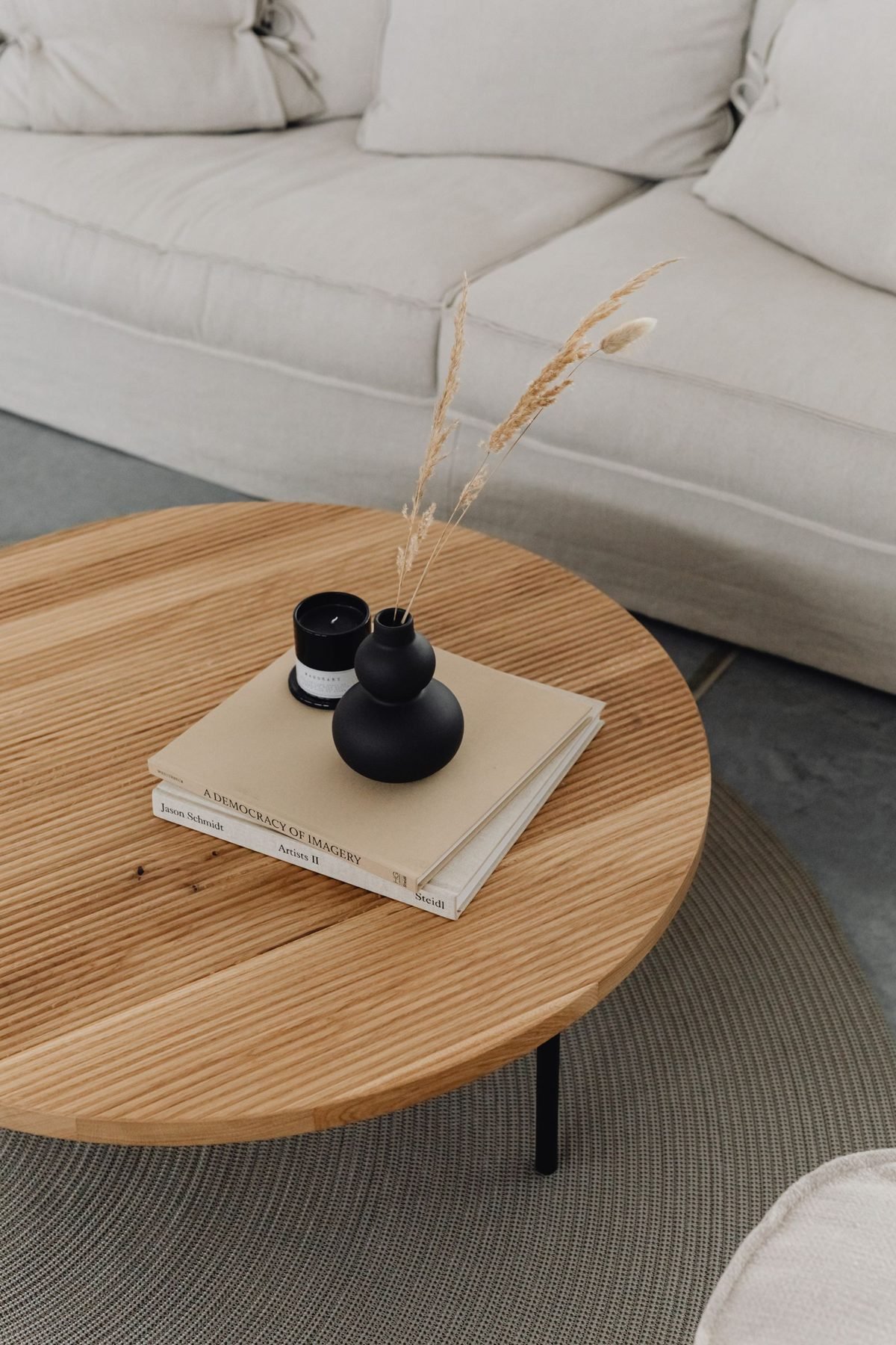 Intentional accessories with a tray, books, and a plant styled neatly on a small living room table