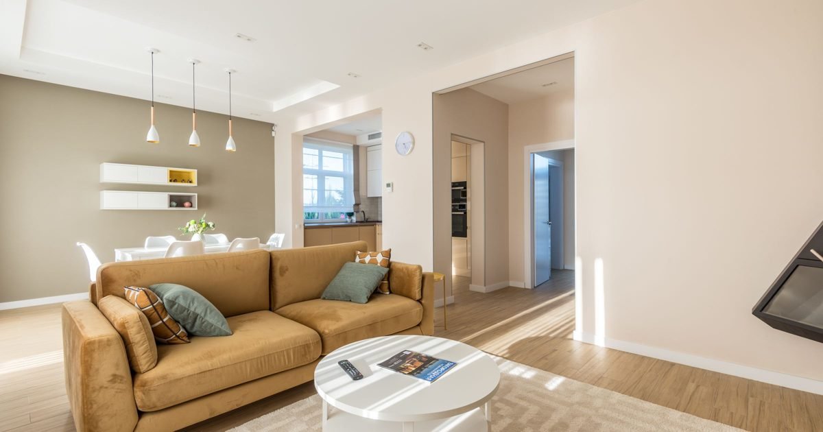 Small living room showing common mistakes like an oversized sofa, clutter, and harsh ceiling light